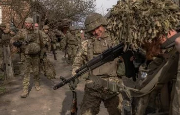 Ukrainian soldiers from the 23rd Mechanized Brigade prepare to head to the front near Avdiivka, Donetsk province, on April 3 amid the Russian invasion of Ukraine. [Roman Pilipey/AFP]