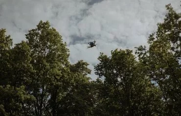 An FPV suicide drone launched by Ukrainian servicemen flies towards Russian positions in Kharkiv province May 16, amid the Russian invasion of Ukraine. [Roman Pilipey/AFP]