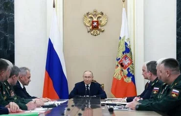 Russian President Vladimir Putin confers with military leaders, including new defense minister Andrei Belousov, in Moscow on May 15. [Gavriil Grigorov/Pool/AFP]