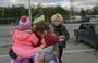 
A Ukrainian woman and her children October 21, 2022, are welcomed in Zaporizhzhia by a relative after they left Russian-occupied territory in Kherson province amid Russia's invasion of Ukraine. [Bulent Kilic/AFP]        