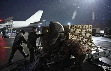 Ukrainian troops unload a plane carrying US military aid at Kyiv's Boryspil airport on February 5, 2022, weeks before Russia invaded. [Genya Savilov/AFP]