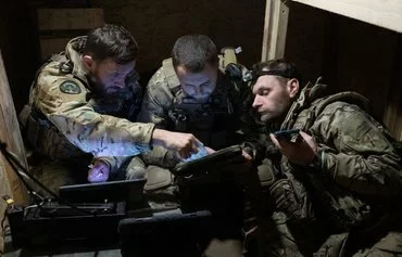 Ukrainian troops prepare to operate a Vampire hexacopter drone over a front line near Chasiv Yar, Donetsk province, on May 1 amid the Russian invasion of Ukraine. The drones drop munitions on Russian targets or deliver supplies including medical necessities to Ukrainian forces. [Genya Savilov/AFP]