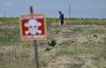 A deminer from the HALO Trust NGO clears mines outside the village of Snigurivka, Mykolaiv province, on June 4 amid the Russian invasion of Ukraine. [Genya Savilov/AFP]