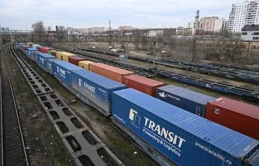 Shipping containers sit on rail trailers on the outskirts of Moscow on April 9. Russia has sought to dodge Western sanctions by setting up parallel imports and a network of traders and intermediaries abroad. [Natalia Kolesnikova/AFP]