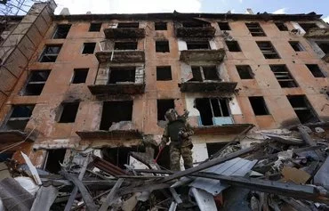 A Russian sapper checks a ruined building in Mariupol, in Russian-controlled Ukraine, on April 19, amid Russia's invasion of Ukraine. [AFP]