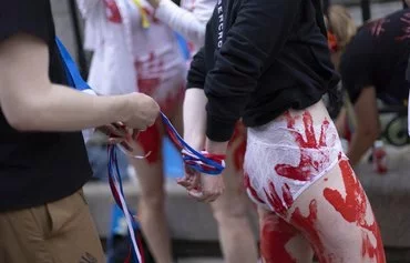 Activists protest rape during war and support Ukraine in front of the Russian consulate in New York on May 28, 2022. [Kena Betancur/AFP]