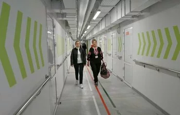 Teachers arrive for classes at Ukraine's first fully underground school, which was built to protect children from Russian missile attacks, in Kharkiv on May 13. [Sergey Bobok/AFP]