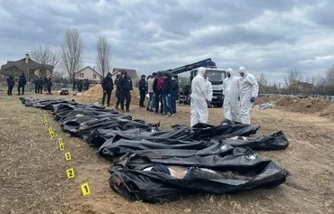 Bodies are exhumed in Bucha, Ukraine, in April 2022. Russian forces, along with Wagner Group mercenaries, are accused of a series of war crimes in the area before retreating. [Ukrainian General Prosecutor Iryna Venediktova/Facebook]