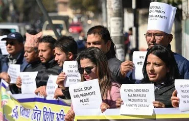 Human rights activists hold placards outside the Russian embassy in Kathmandu, Nepal, on February 5 to protest the recruitment of Nepalese nationals into the Russian army. [Prakash Mathema/AFP]