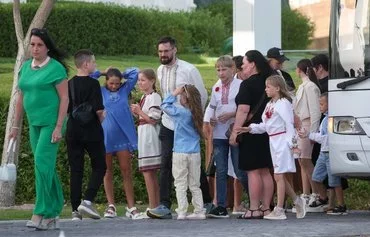 Ukrainian children and their families arrive to meet with Qatari Minister of State for International Cooperation Lolwah bint Rashid Al-Khater (not pictured) in Doha on April 24. Al-Khater brokered a deal between Russia and Ukraine to exchange almost 50 children displaced by Moscow's invasion of Ukraine. [Karim Jaafar/AFP]