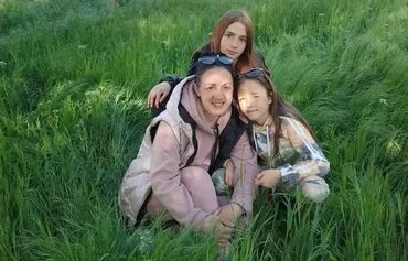 Irina Trefelyeva, pictured here with her two daughters, reunited with them after four months' separation. They were held at a Russian re-education camp in Crimea from October 2022 to February 2023. [Irina Trefelyeva personal archive]