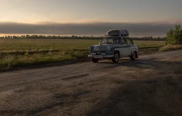 People drive a car loaded with luggage from Toretsk, Donetsk province, on June 24, amid the Russian invasion of Ukraine. [Roman Pilipey/AFP]