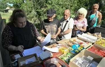 Postwoman Ganna Fesenko distributes pensions to residents of the village of Novoselydivka on June 14. [Genya Savilov/AFP]