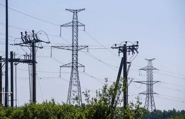 Electrical transmission towers of the Kurzeme Circle (Kurzemes Loks) are pictured in 2020 in Sloka, near Riga, Latvia. [Gints Ivuskans/AFP]