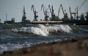 Waves wash over the shore along the seaport of Mariupol, in Russian-controlled Ukraine. [AFP]