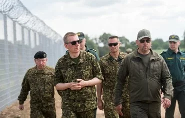 Latvian President Edgars Rinkēvičs (2nd left) inspects the construction of a border wall in Karsava, Latvia, near the Baltic country's border with Russia, on June 18. [Gints Ivuskans/AFP]