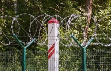 A Latvian border post is seen at a section of newly erected fence near the border with Russia in Karsava, Latvia, on June 18. [Gints Ivuskans/AFP]