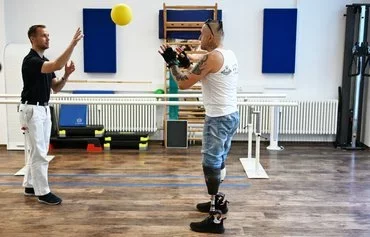 Double amputee Vitaliy Saiko, a veteran of the war in Ukraine, trains with orthopedic technician Michael Köhler in Berlin July 25. [Ralf Hirschberger/AFP]