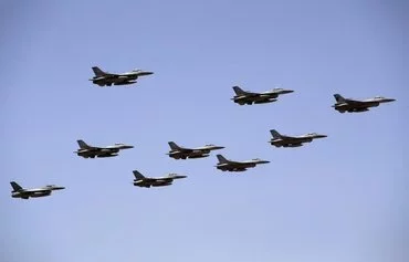 A squadron of US-made F-16s participate in an air show at Balad Air Base north of Baghdad on April 24. [Ahmad Al-Rubaye/AFP]