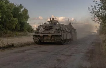 Ukrainian servicemen operate an armored military vehicle in Sumy province, near the border with Russia, on August 12, amid the Russian invasion of Ukraine. [Roman Pilipey/AFP]