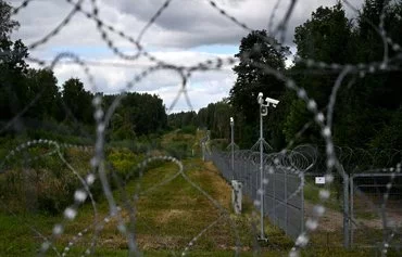 A razor wire boundary fence is seen along the Polish-Lithuanian border with the Russian exclave of Kaliningrad in Wisztyniec, Poland, on August 12. [Sergei Gapon/AFP]