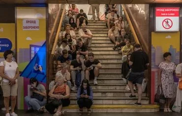 People take shelter in the Teatralna subway station station during a Russian air attack in Kyiv on August 26. [Roman Pilipey/AFP]