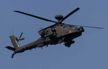 A US Army AH64 Apache helicopter takes part in a military parade in Warsaw on August 15 to commemorate the 104th anniversary of the Polish victory in the 1920 Polish–Soviet War. [Wojtek Radwanski/AFP]