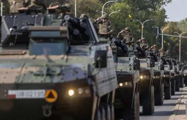 Polish soldiers August 15 take part in a military parade in Warsaw on Polish Army Day. [Wojtek Radwanski/AFP]