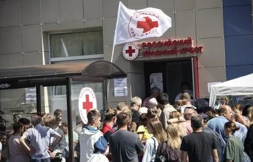 War-displaced inhabitants receive humanitarian aid at a Russian Red Cross distribution point in Kursk city on August 15 following Ukraine's offensive into Kursk province, Russia. [Tatyana Makeyeva/AFP]