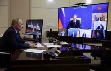 In this pool photograph distributed by Russian state owned Sputnik agency, President Vladimir Putin chairs a meeting via video link at the Novo-Ogaryovo residence outside Moscow on August 22. [Gavriil Grigorov/Pool/AFP]