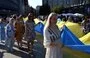 
Members of the Ukrainian diaspora in Poland unfurl a 100-metre Ukrainian flag in Katowice, Silesian region, to mark Ukraine's Independence Day on August 24. [Sergei Gapon/AFP]        