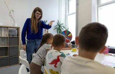 Paulina Skrzypek runs classes for Ukrainian children aged 7-9 in Lublin, on August 6, at the headquarters of the non-governmental Homo Faber organisation, which holds language courses for Ukrainian pupils attending Polish schools. [Wojtek Radwanski/AFP]