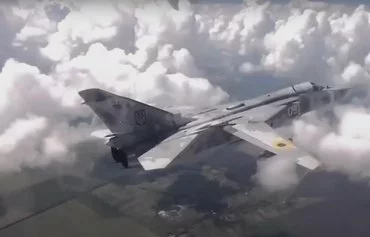 A screenshot from a video the Ukrainian Air Force posted on social media in August shows the Ukrainian Su-24 bomber carrying a prototype of a gliding munition under its wing. [File]