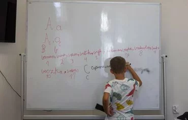 The language barrier is among the challenges that Ukrainian children face in Polish schools and that deter them from wanting to attend school. A Ukrainian pupil takes part in a language class for Ukrainian children enrolled in Polish schools in Lublin on August 6. [Wojtek Radwanski/AFP]