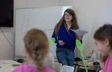 Paulina Skrzypek on August 6 runs classes for Ukrainian children aged 7-9 in Lublin, at the headquarters of the non-governmental Homo Faber organisation, which launched language courses for Ukrainian pupils enrolled in Polish schools. [Wojtek Radwanski/AFP]