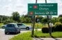 
Cars head past a road sign directing them toward Bezledy, Poland, a village on the Russian border, on August 1. [Mateusz Slodkowski/AFP]        