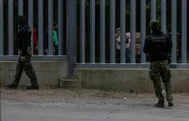 Polish border guards patrol the wall along the frontier with Belarus not far from Bialowieza, Poland, on May 29, 2023. [Wojtek Radwanski/AFP]