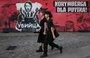 
A couple walks past a banner depicting Russian President Vladimir Putin and reading 'Killer' and 'Nuremberg for Putin' in Wroclaw, Poland, on September 20. [Sergei Gapon/AFP]        