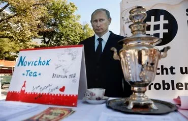 A mock offer of 'Novichok Tea' is seen in front of an effigy of Russian President Vladimir Putin outside the Russian embassy in Berlin during a protest September 23, 2020. [Odd Andersen/AFP]