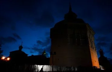 A man walks in front of the medieval Trinity Lavra of Saint Sergius in Sergiev Posad, 70km from Moscow, on July 22, 2018. Russian military personnel are expanding a Soviet-era bioweapon lab in Sergiev Posad-6, a closed military town. [Kirill Kudryavtsev/AFP]