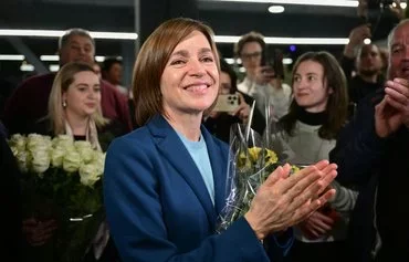 Moldovan President Maia Sandu celebrates with staff and supporters following preliminary results of the second round of the presidential election in Chisinau November 3. [Daniel Mihailescu/AFP]