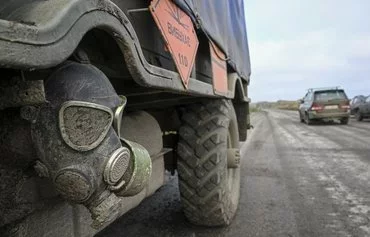 A Russian gas mask adorns the vehicle of a Ukrainian mine-clearing unit on a road near Izyum, Ukraine, on October 1, 2022, amid the Russian invasion of Ukraine. [Juan Barreto/AFP]