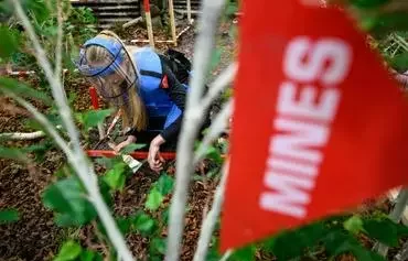 Ukrainian mine-clearing specialist Nadiia Kudryavtseva, who works for the Swiss Demining Foundation (FSD), performs a mine clearance demonstration on the opening day of the Ukraine Mine Action Conference 2024 in Lausanne, Switzerland, on October 17. [Fabrice Coffrini/AFP]