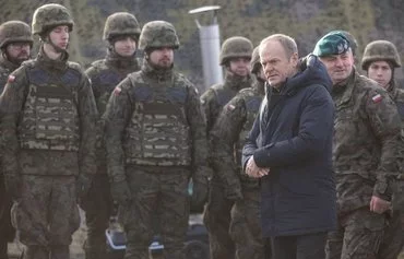 Polish Prime Minister Donald Tusk (2nd right) and Chief of the Military Engineering Branch Gen. Marek Wawrzyniak (right) arrive to inspect the first completed section of East Shield fortifications on the Polish-Russian border near Dąbrówka, Poland, on November 30. [Wojtek Radwanski/AFP]