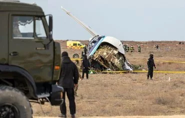 Emergency specialists work at the Azerbaijan Airlines crash site near Aktau, Kazakhstan, on December 25. [Issa Tazhenbayev/AFP]