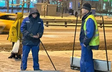 Uzbek migrant workers are shown clearing snow in Moscow on February 23, 2023. [Daniil Karimov]