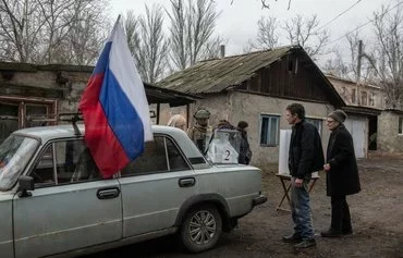 Residents vote at a mobile polling station in Russia's presidential election in Donetsk, Russian-controlled Ukraine, amid the Russia-Ukraine conflict on March 14, 2024. [AFP]