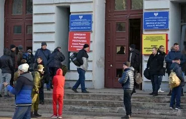 Men are shown at a military mobilization point in a Palace of Culture in Donetsk, Russian-occupied Ukraine, February 20, 2022. [AFP]