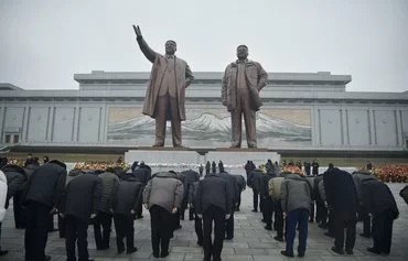 North Koreans pay tribute to the statues of late North Korean leaders Kim Il Sung and Kim Jong Il on Mansu Hill on the 83rd birthday of Kim Jong Il in Pyongyang on February 16. [Kim Won Jin/AFP]